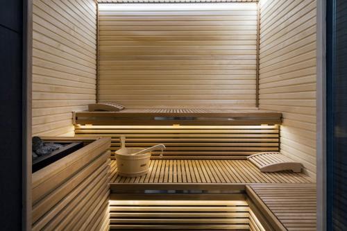 a sauna with two beds and a bench in it at LHP Hotel River & SPA in Florence