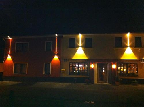 a house with lights on the side of it at night at Landgasthof Zur Erholung in Breitscheid