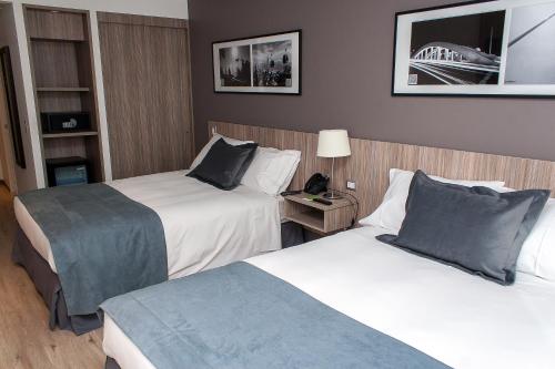 Postel nebo postele na pokoji v ubytování Hotel Capital Bellet