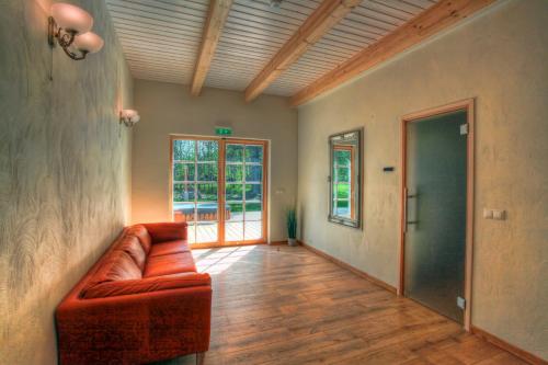 a living room with a leather couch and a window at Villa Pillapalu in Pillapalu