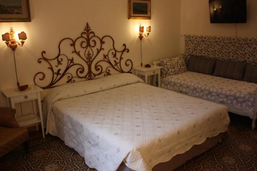 a bedroom with a large bed and a couch at Rooms by Anna Affittacamere in Florence