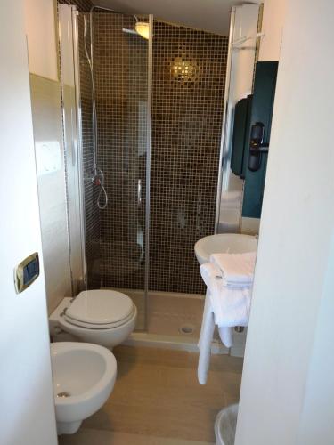 a bathroom with a shower and a toilet and a sink at Villa Celeste B&B in Pontecagnano