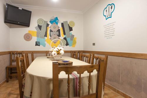 a dining room with a table with flowers on it at Casa Rural Lagun Etxea in Pobes