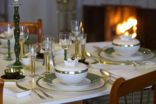 stół z talerzami, kieliszkami do wina i sztućcami w obiekcie Brunnbäcks Herrgård w mieście Mästerbo