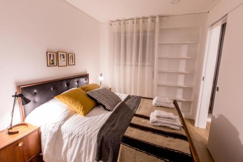 a bedroom with a large bed with a wooden headboard at Casa do Tanque in Arouca