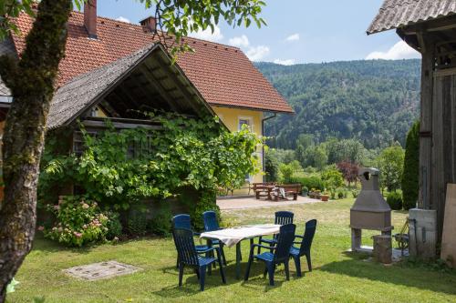 a table and chairs in the yard of a house at Apartment House Andrej in Bohinj