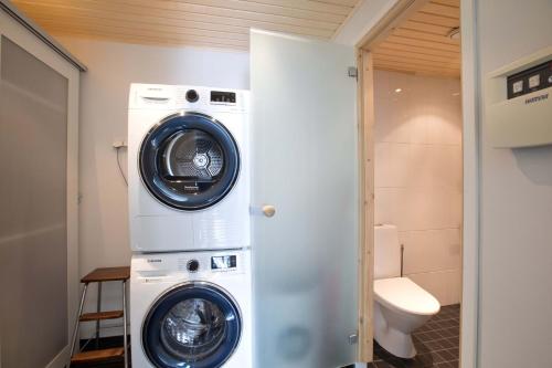 a washer and dryer in a small bathroom at Arctic Suite in Rovaniemi