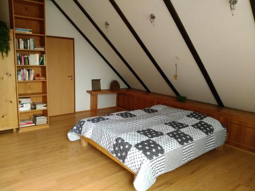 a bedroom with a bed and a book shelf at Katharina in Kempen