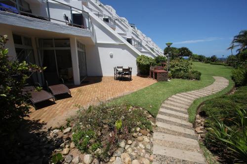 a house with a brick walkway next to a yard at First Group La Cote D'Azur in Margate