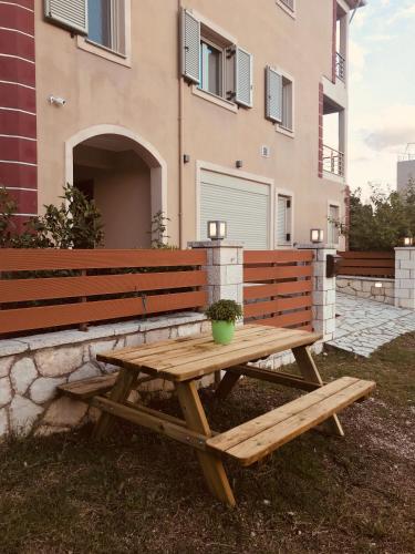 a wooden picnic table in front of a building at Villa Lydia in Nydri