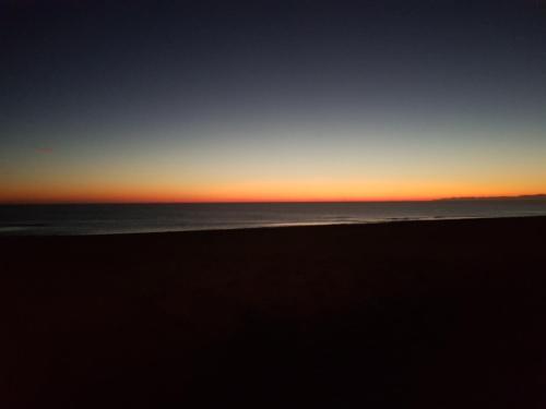 a view of the ocean at sunset at Appartement au Centre de Martil in Martil