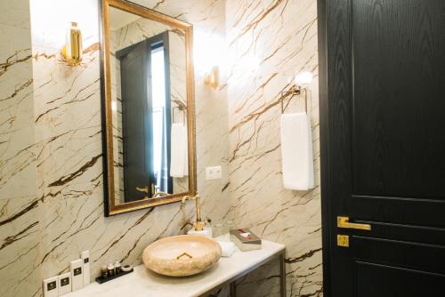 a bathroom with a sink and a mirror at King Gorgasali in Tbilisi City