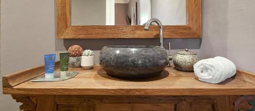 a bathroom counter with a large bowl sink on it at La Indiana de Begur, Petit Hotel Boutique in Begur