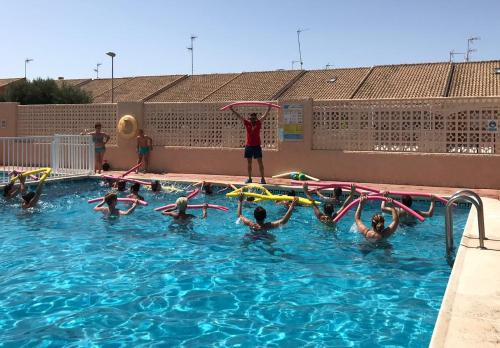 a group of people playing in a swimming pool at Destinos De Sol Los Alcazares - Montepío Minería in Los Alcázares