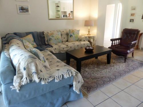 a living room with a couch and a coffee table at Sole's Leap in Scottburgh