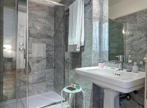 a bathroom with a sink and a shower at Grand Hotel Plaza in Rome