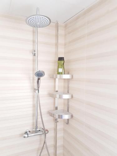 a shower with two shelves in a bathroom at Apartamentos Los Corralejos in Fuengirola
