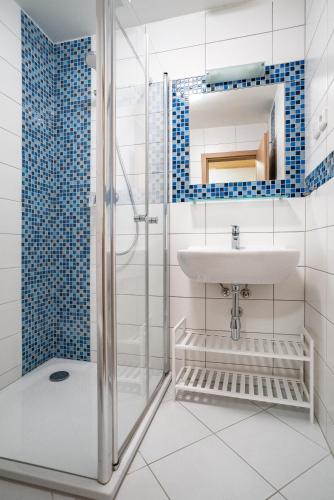 a bathroom with a sink and a shower at S4 Resort Kouty in Loučná nad Desnou