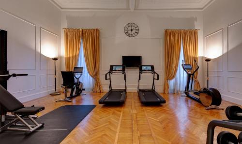 a gym with several exercise equipment in a room at Grand Hotel Plaza in Rome