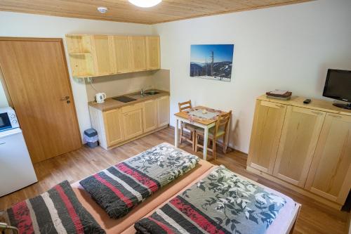 a small room with a kitchen and a table at S4 Resort Kouty in Loučná nad Desnou
