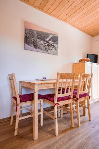 a wooden table and two chairs in a room at S4 Resort Kouty in Loučná nad Desnou