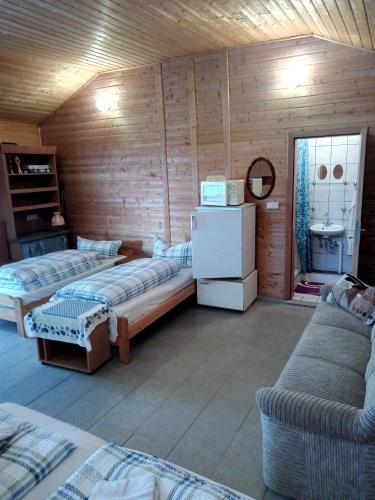 a room with two beds in a wooden room at Pension Fischer in Plauen