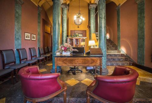 a waiting room with a desk and chairs in a building at Hotel Terme in Sarnano