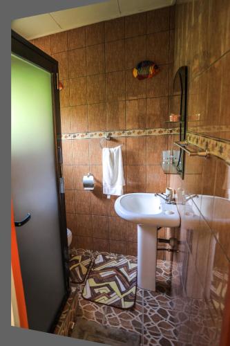 a bathroom with a sink and a tub and a sink at Dream Holiday Self Catering in La Digue