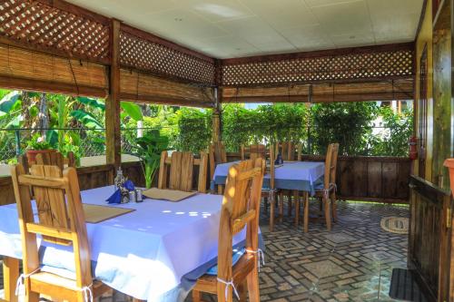 a dining room with a table and chairs in at Dream Holiday Self Catering in La Digue