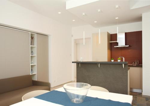 a kitchen with a table with a bowl on it at Sea Windows Suite in Trapani