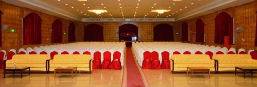 a large room with red and white chairs in it at Ramee Dream Resort in Seeb