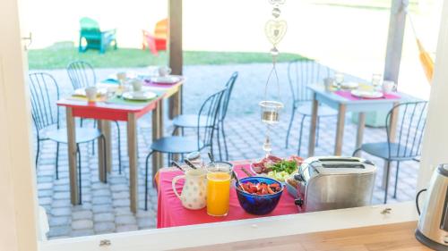a table with food and drinks on a patio at Treehouseestonia in Jõgisoo