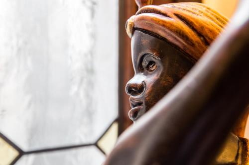 a wooden statue of a face on a table at Antica Locanda Sturion Residenza d'Epoca in Venice