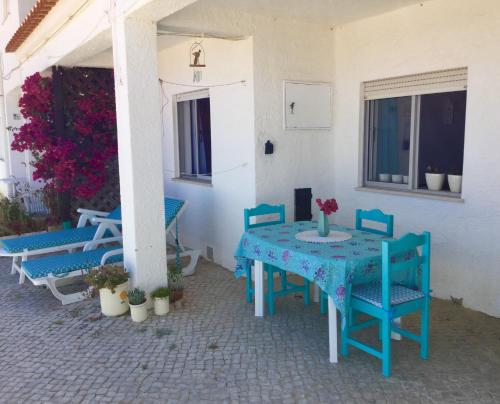 a blue table and chairs on a patio at DOCEVIDA Appartement # Ocean View in Salema