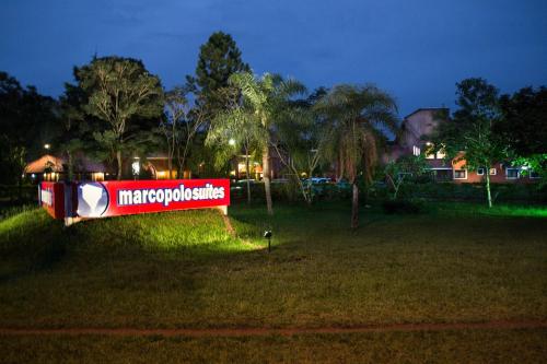 a sign in the grass in a park at night at Marcopolo Suites Iguazu in Puerto Iguazú