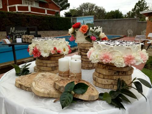 a table with candles and flowers on top of it at Maison entière ChezSoa, antananarivo in Andoharanofotsy