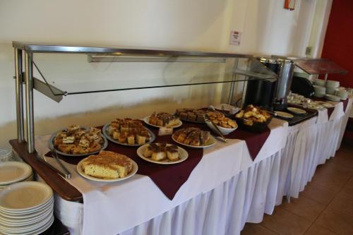 a buffet line with many different types of food at Marcopolo Suites Iguazu in Puerto Iguazú