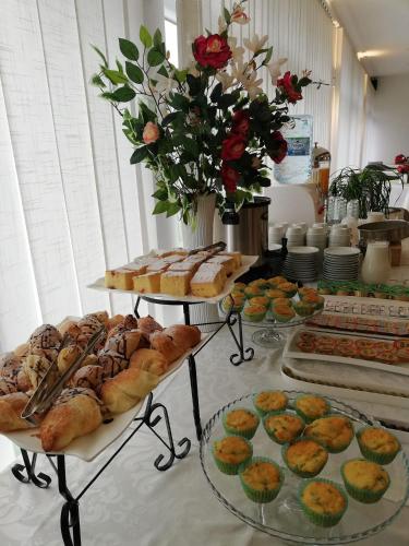 a buffet filled with different types of bread and pastries at Hotel Village in Ohrid