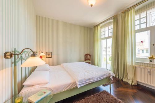 a bedroom with a bed with a lamp and a window at Ferienwohnung Seemuschel in Binz