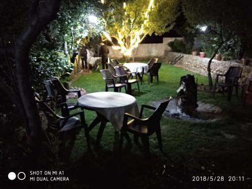 a group of tables and chairs in a yard at night at Hotel Mountain face by Snow City Hotels in Manāli