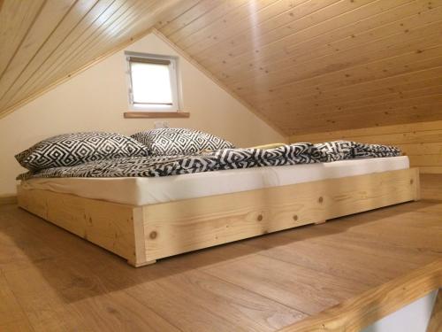 łóżko na poddaszu pokoju w obiekcie Domki U Moniki w mieście Grywałd