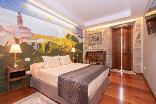 a bedroom with a bed and a painting on the wall at Pazo de Esposende in Esposende
