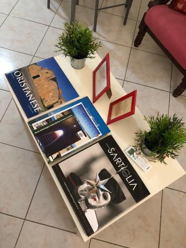 a table with a magazine and a loaf of bread on it at Gaia House in Oristano