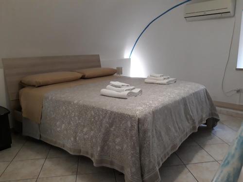 a bedroom with a bed with two towels on it at CETARA - ALBERGO DIFFUSO in Cetara