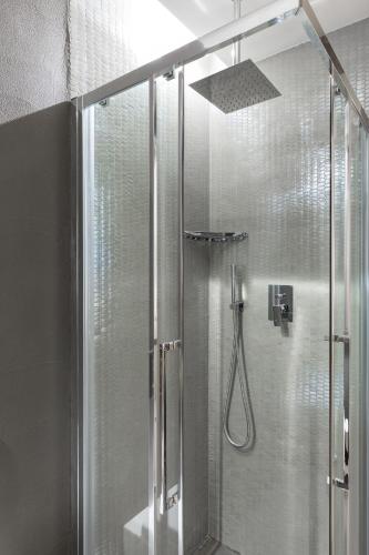 a shower with a glass door in a bathroom at A World Aparts - Barberini Boutique Hotel in Rome
