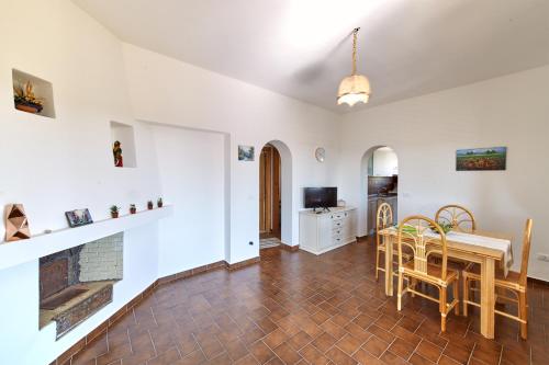 a living room with a table and a fireplace at Capo Grillo Cottage Villa in Vulcano