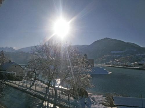 a sun shining over a body of water at Cherry flower ( Trešnjin Cvet ) apartment in Višegrad