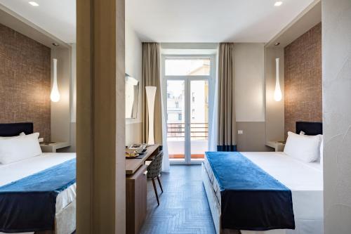 Postel nebo postele na pokoji v ubytování A World Aparts - Barberini Boutique Hotel