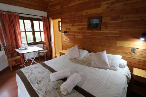 a bedroom with a bed with two towels on it at Santa Maria Pucon in Pucón
