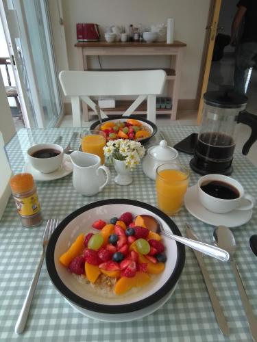 a table with a plate of fruit on a table at Burren Rock Farmhouse B&B in Turlough